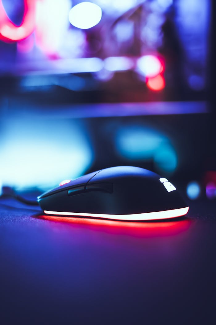 Close-up of a gaming mouse with glowing LED lights, featuring a blurred tech background.